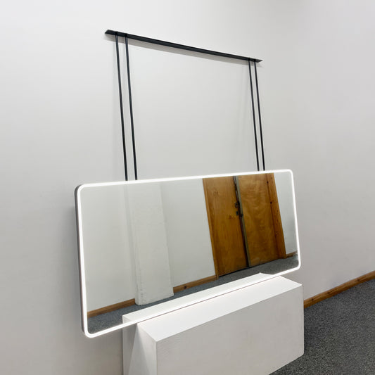 Oversized modern ceiling suspended Quadris™ front illuminated rectangular double sided mirror with a handcrafted blackened metal frame