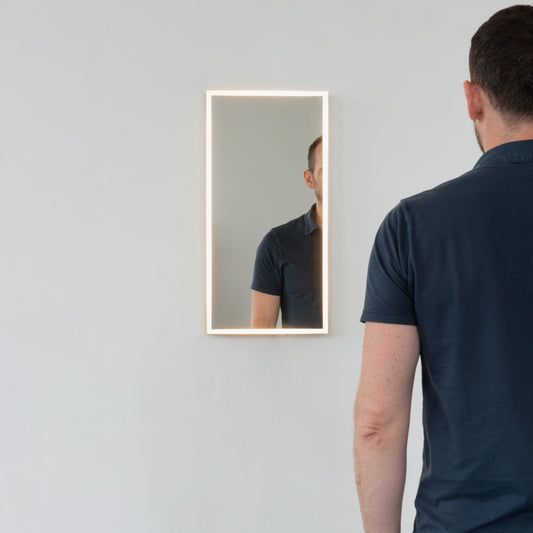 Front illuminated Quadris™ rectangular mirror with square corners and a solid brushed brass frame