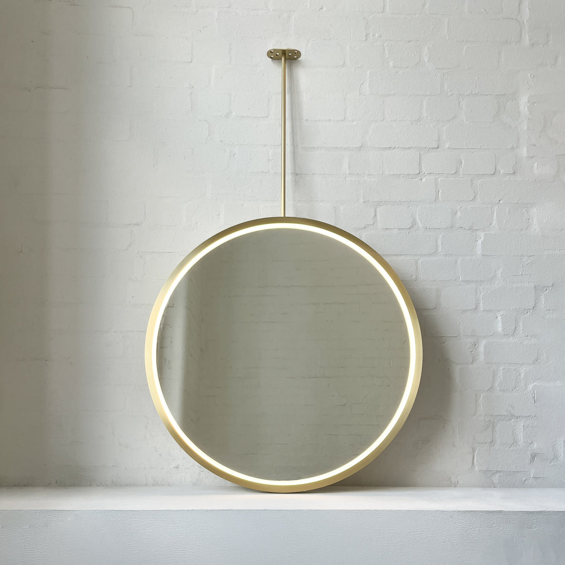 Ceiling Suspended Orbis™ Illuminated Mirror with Full Brass Frame