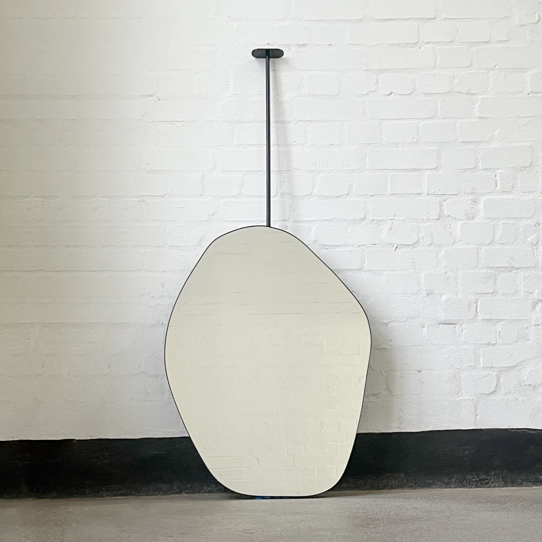New Ceiling-Suspended Freeform Mirror with Minimalist Black Frame