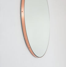 Modern round mirror with a minimalist copper frame