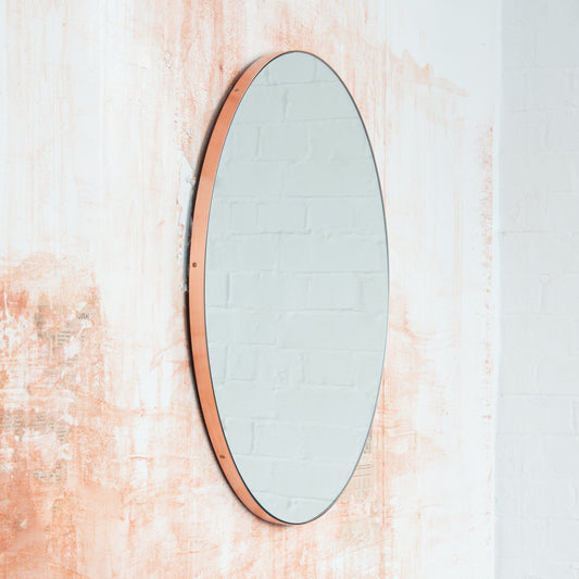 Modern round mirror with a minimalist copper frame