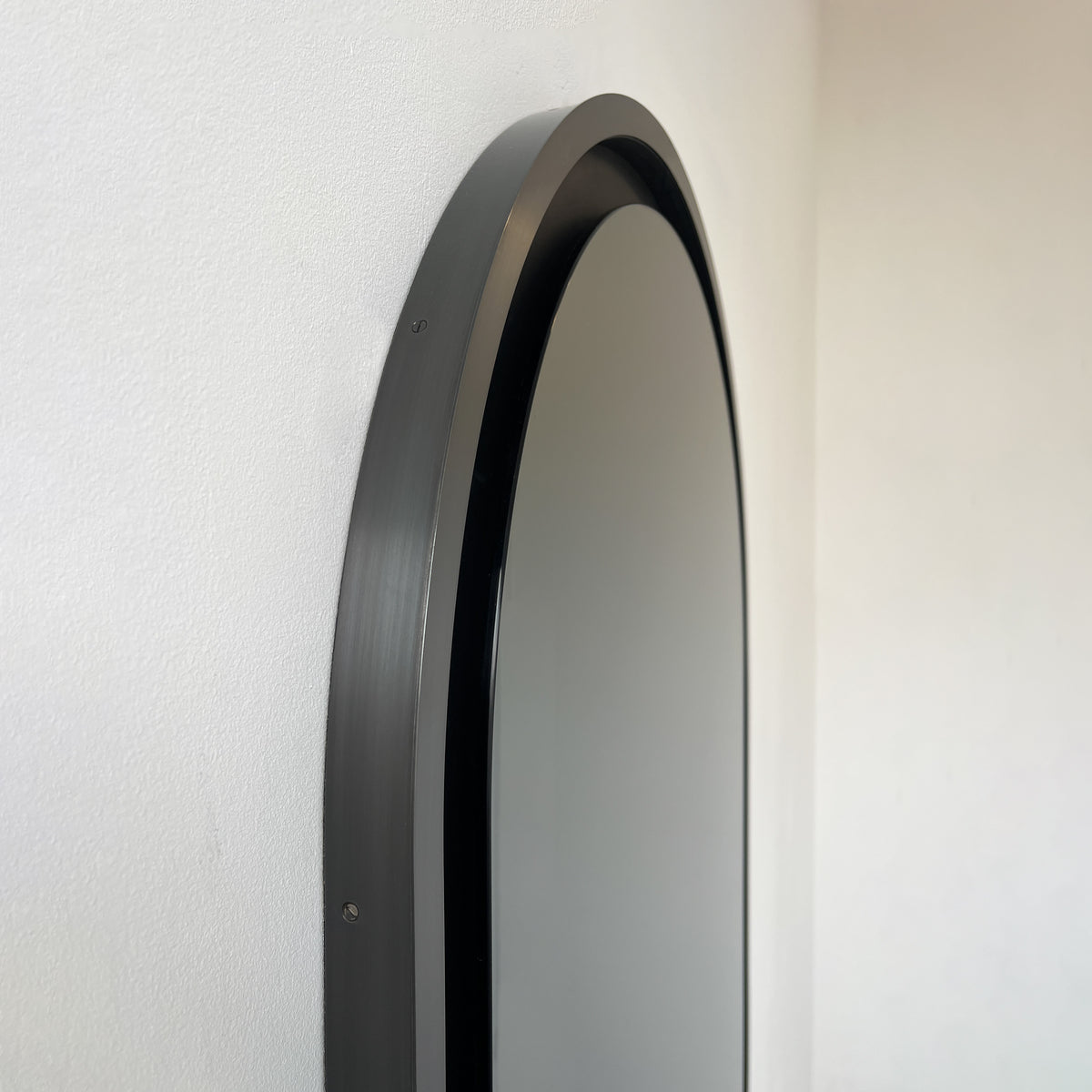 Alguacil & Perkoff illuminated arch shaped black mirror with a contemporary blackened metal frame