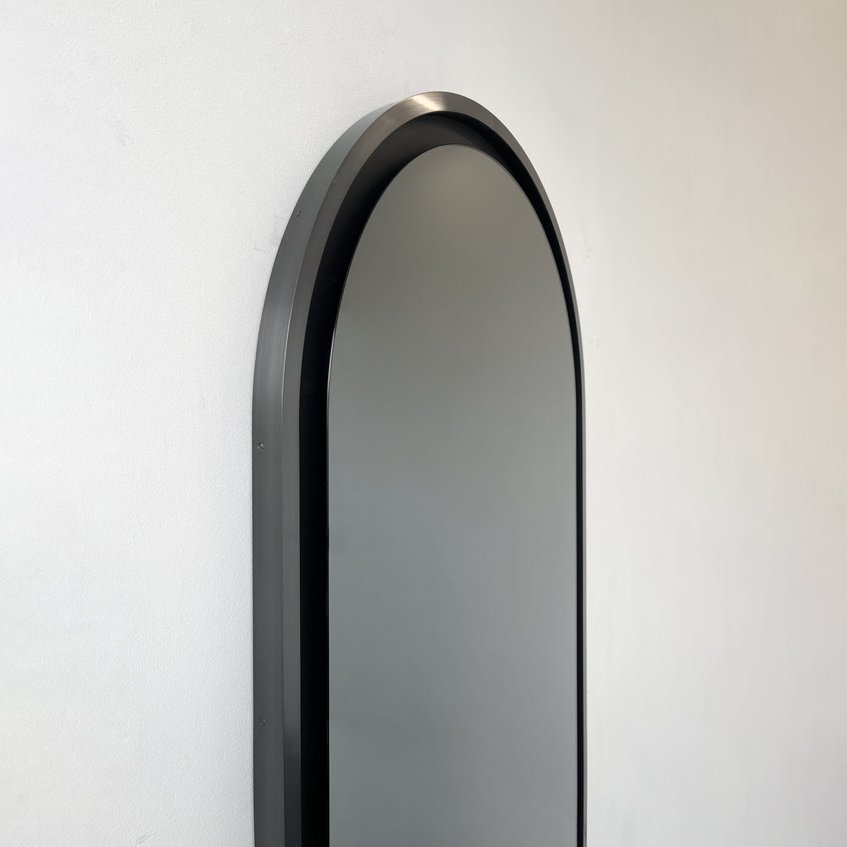 Alguacil & Perkoff illuminated arch shaped black mirror with a contemporary blackened metal frame