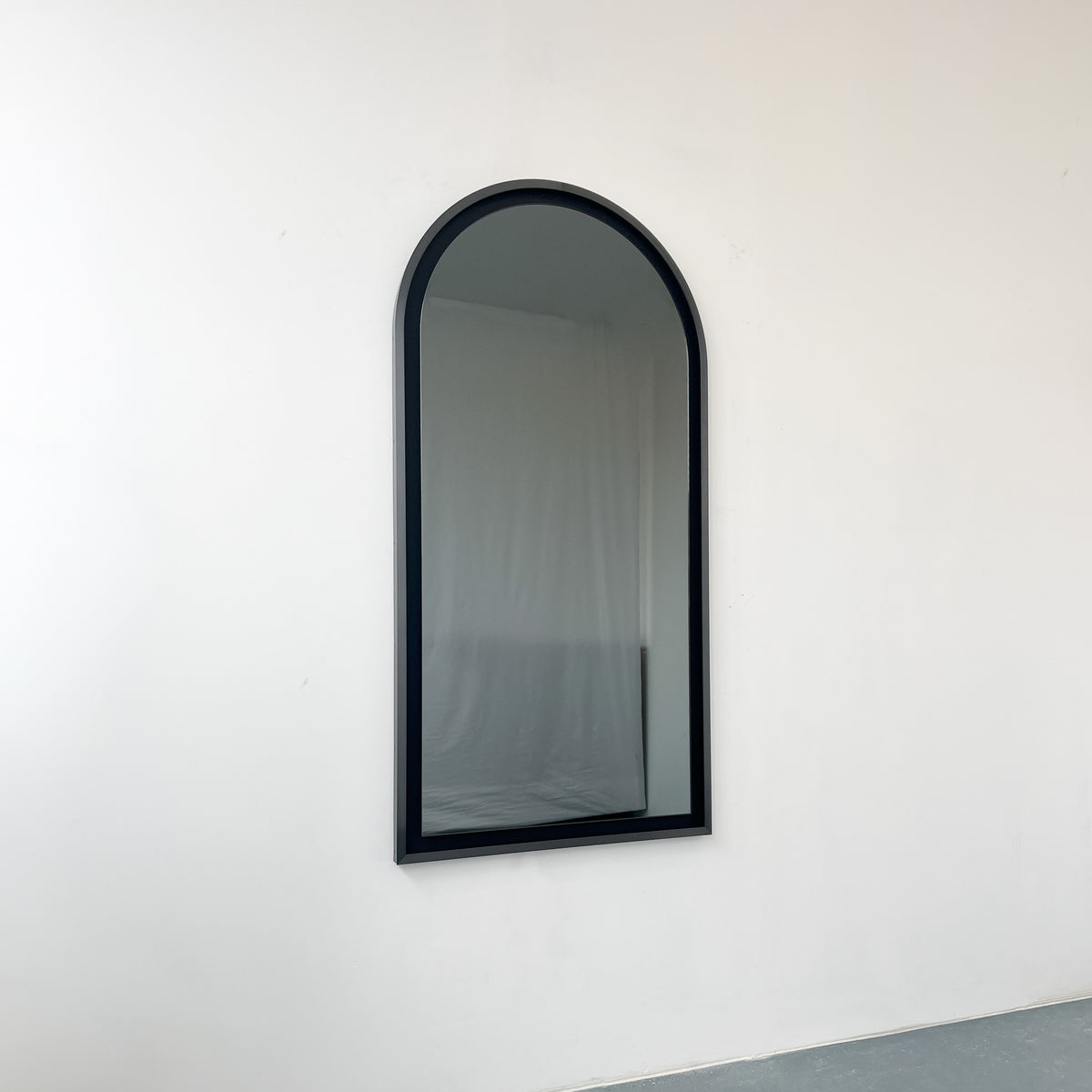 Alguacil & Perkoff illuminated arch shaped black mirror with a contemporary blackened metal frame