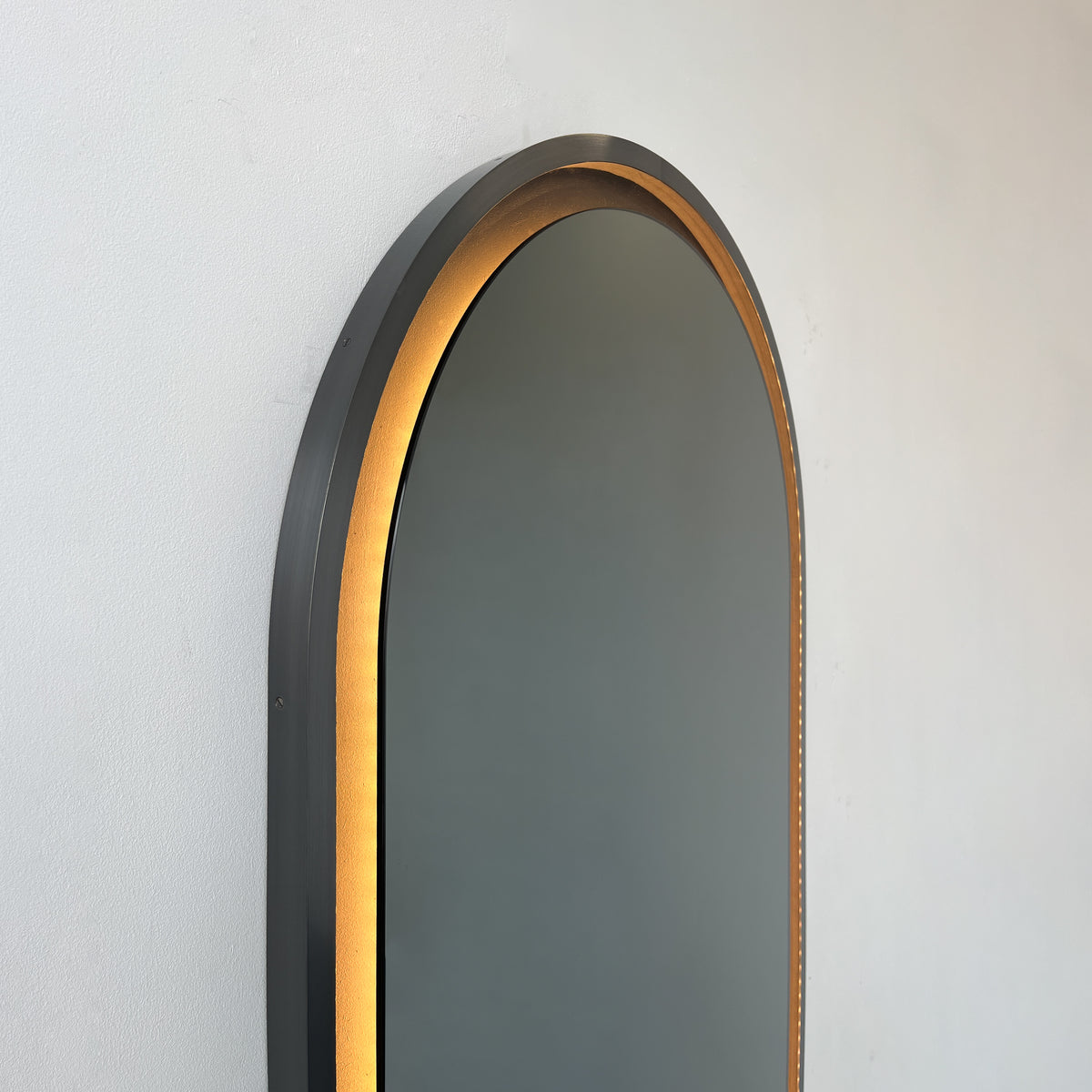Alguacil & Perkoff illuminated arch shaped black mirror with a contemporary blackened metal frame
