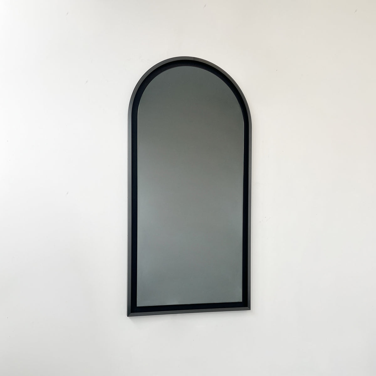 Alguacil & Perkoff illuminated arch shaped black mirror with a contemporary blackened metal frame