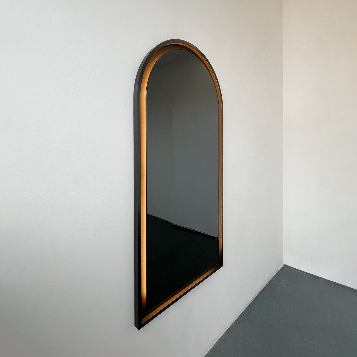 Alguacil & Perkoff illuminated arch shaped black mirror with a contemporary blackened metal frame