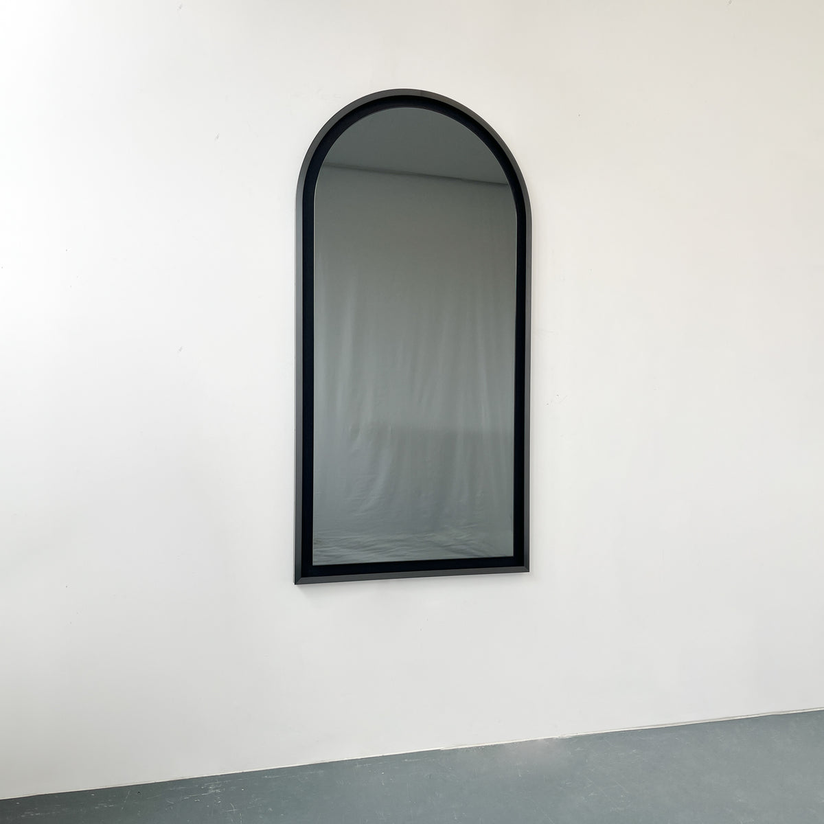 Alguacil & Perkoff illuminated arch shaped black mirror with a contemporary blackened metal frame