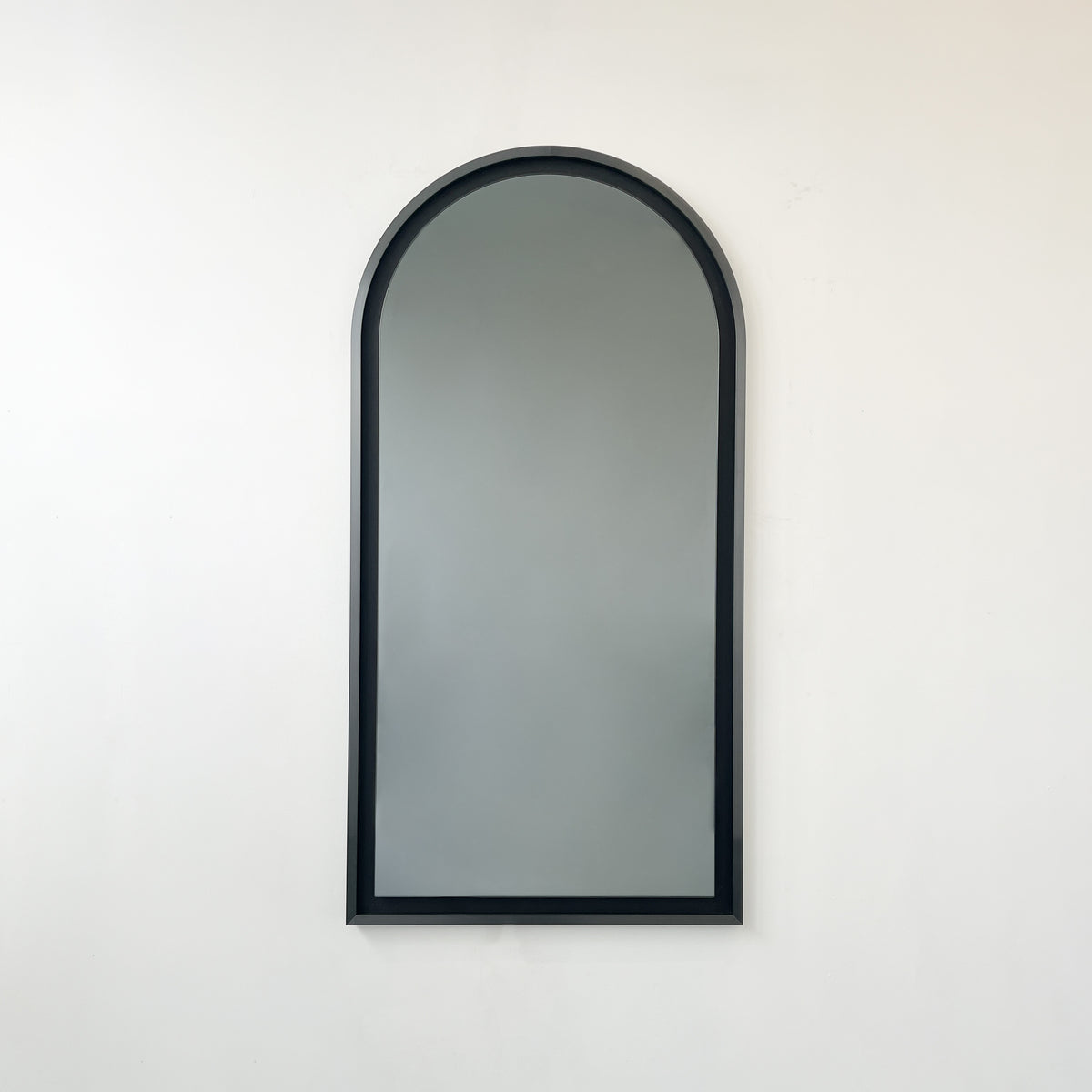 Alguacil & Perkoff illuminated arch shaped black mirror with a contemporary blackened metal frame