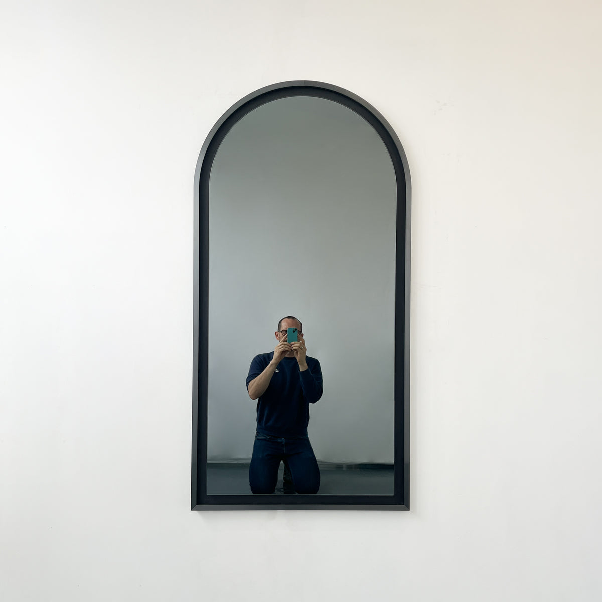 Alguacil & Perkoff illuminated arch shaped black mirror with a contemporary blackened metal frame