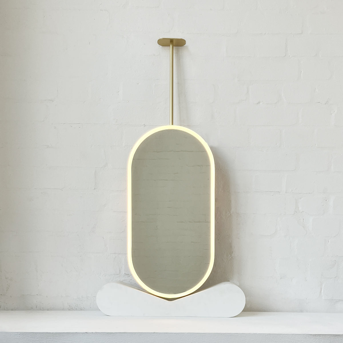 Capsula™ Ceiling Suspended Contemporary Mirror with a Brass Frame and Front Illumination