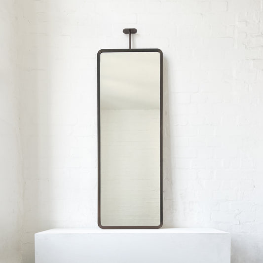 Modern ceiling suspended Quadris™ rectangular mirror with a handcrafted brass frame with a bronze patina finish