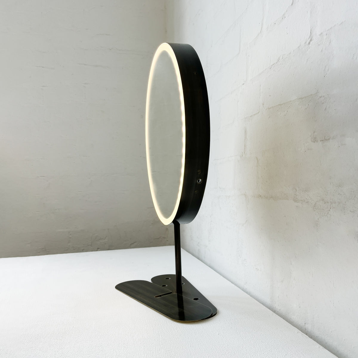Contemporary Illuminated Orbis™ Countertop Round Mirror with Bronze Patina Frame
