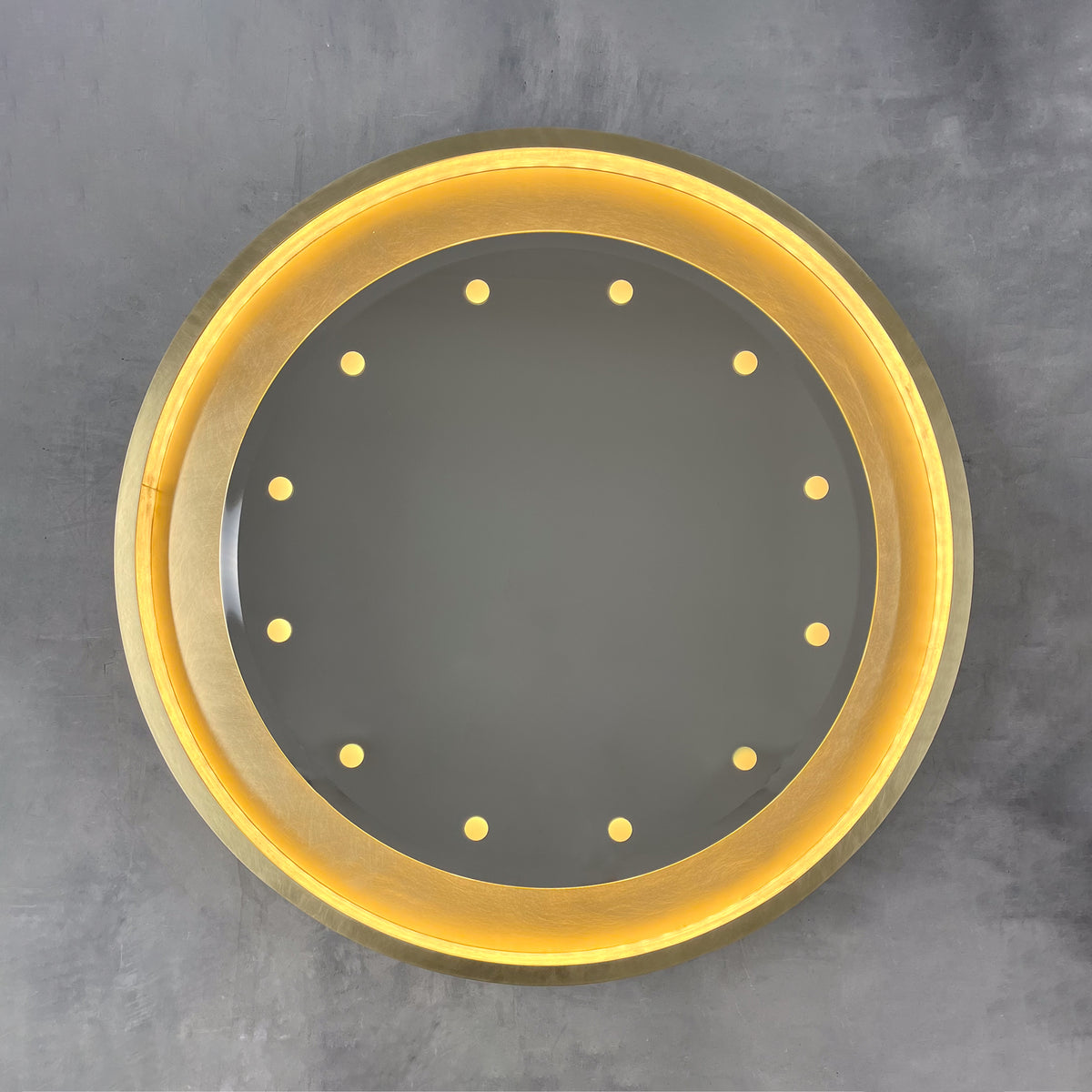 Special edition bevelled Orbis™ round mirror with a floating reflective surface, exquisite handcrafted brushed brass frame and bespoke illumination.