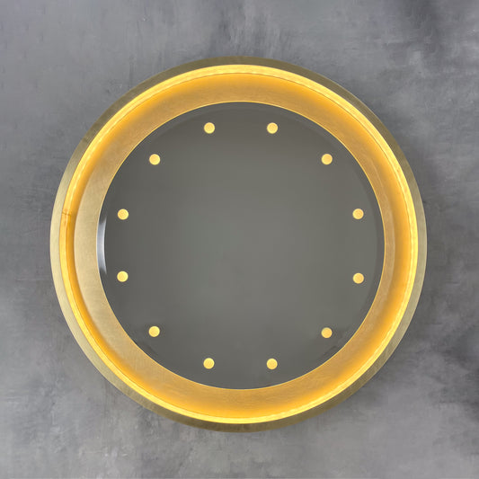 Special edition bevelled Orbis™ round mirror with a floating reflective surface, exquisite handcrafted brushed brass frame and bespoke illumination.