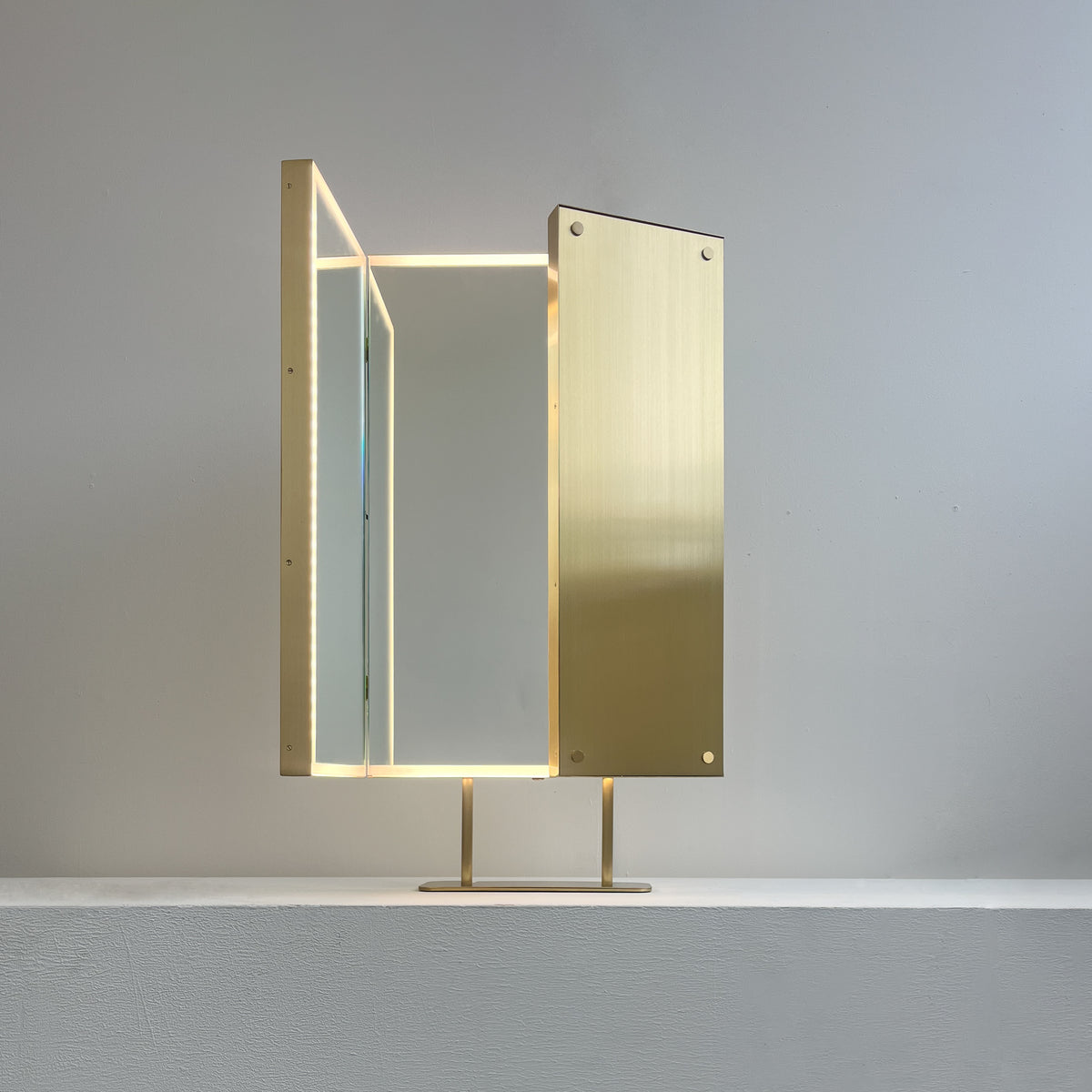 Illuminated Triptych Countertop Mirror with Brushed Brass Frame
