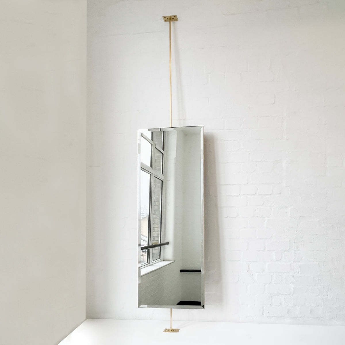 Countertop to Ceiling Rectangular Mirror with a Bevel and a Brass Frame