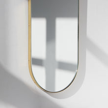 Capsula™ Capsule shaped Modern Mirror with an Elegant Brass Frame