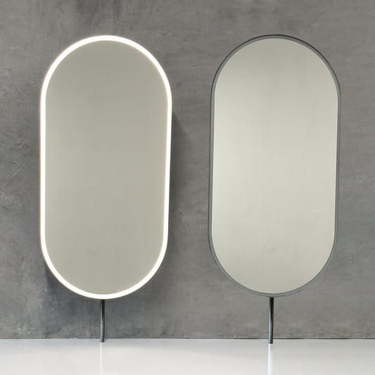 Set of two modern front illuminated Capsula™ countertop pill shaped mirrors with a minimalist blackened stainless steel frame