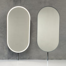 Set of two modern front illuminated Capsula™ countertop pill shaped mirrors with a minimalist blackened stainless steel frame