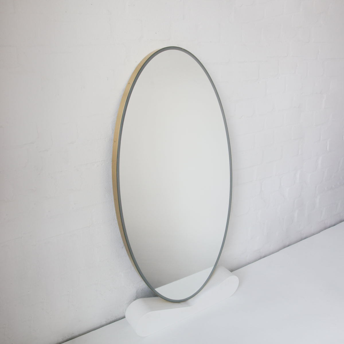 Ovalis™ Oval shaped Front Illuminated Modern Large Mirror with a Brushed Brass Frame