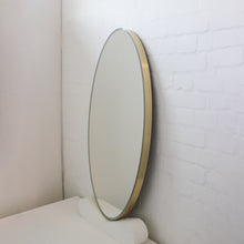 Ovalis™ Oval shaped Front Illuminated Modern Large Mirror with a Brushed Brass Frame