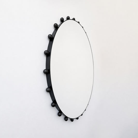 Alguacil & Perkoff Special Edition round mirror with decorative bobbins and a handcrafted blackened metal minimalist frame