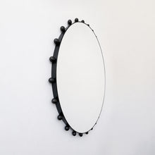Alguacil & Perkoff Special Edition round mirror with decorative bobbins and a handcrafted blackened metal minimalist frame