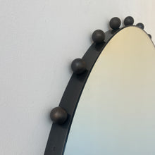 Alguacil & Perkoff Special Edition round mirror with decorative bobbins and a handcrafted blackened metal minimalist frame