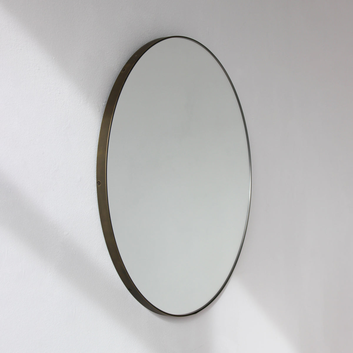Orbis™ Round Mirror with a Minimalist Handcrafted Bronze Patina Frame