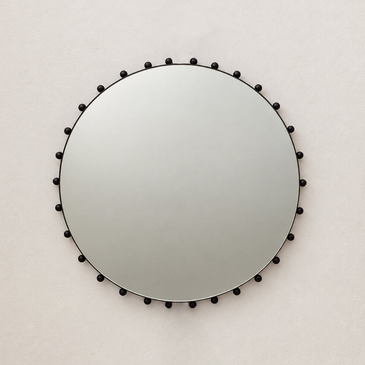 Alguacil & Perkoff Special Edition round mirror with decorative bobbins and a handcrafted blackened metal minimalist frame