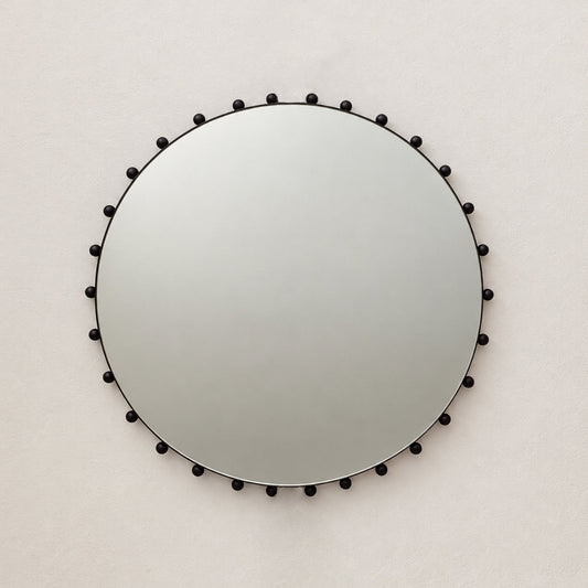 Alguacil & Perkoff Special Edition round mirror with decorative bobbins and a handcrafted blackened metal minimalist frame