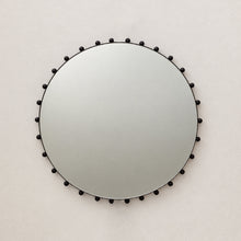 Alguacil & Perkoff Special Edition round mirror with decorative bobbins and a handcrafted blackened metal minimalist frame