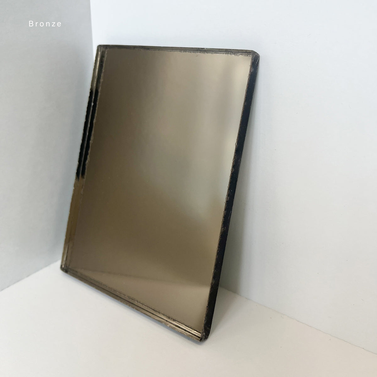 Capsula™ Capsule shaped Bronze Contemporary Mirror with a Black Frame