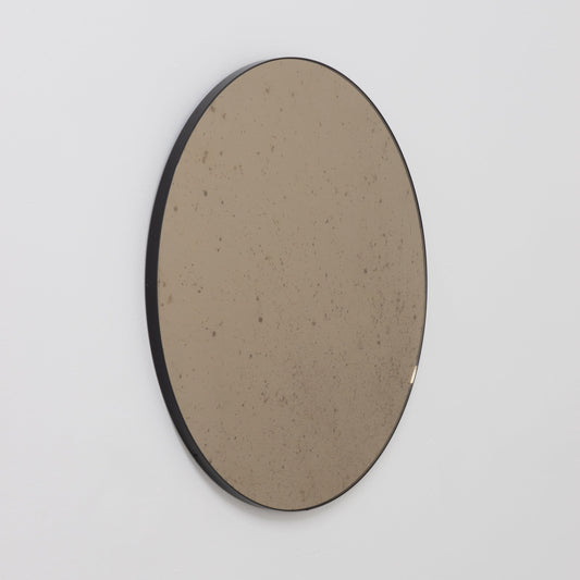 Orbis™ Antiqued Bronze Tinted Round Elegant Mirror with a Black Frame