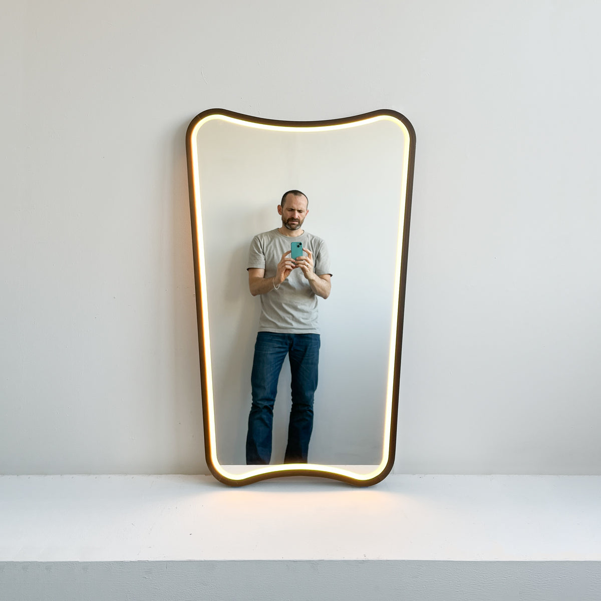 Mid-century inspired Wall Mirror with Front Illumination and Bronze Patina Frame
