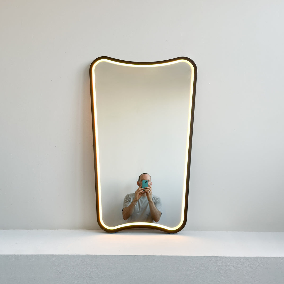 Mid-century inspired Wall Mirror with Front Illumination and Bronze Patina Frame