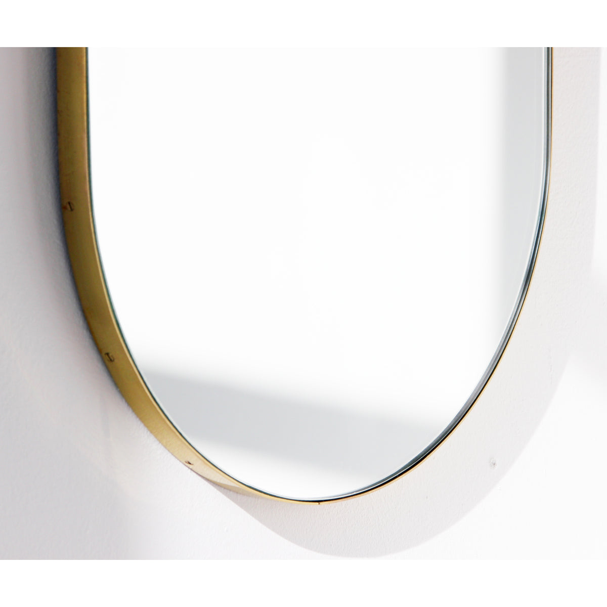 Capsula™ Suspended Capsule shaped Bathroom Mirror with a Brushed Brass Frame