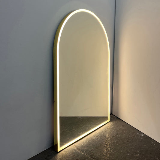 Contemporary front illuminated arch shaped Arcus™ mirror with a solid brass frame