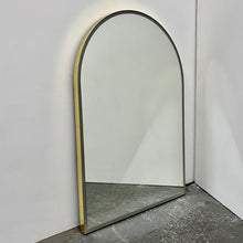 Contemporary front illuminated arch shaped Arcus™ mirror with a solid brass frame