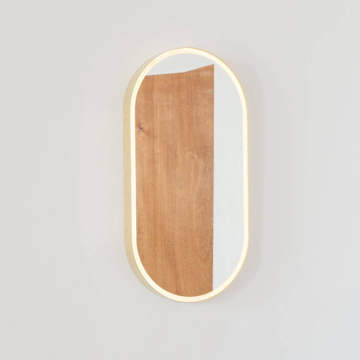 Capsula™ Front Illuminated Capsule shaped Mirror with Elegant Brushed Brass Frame, Customisable