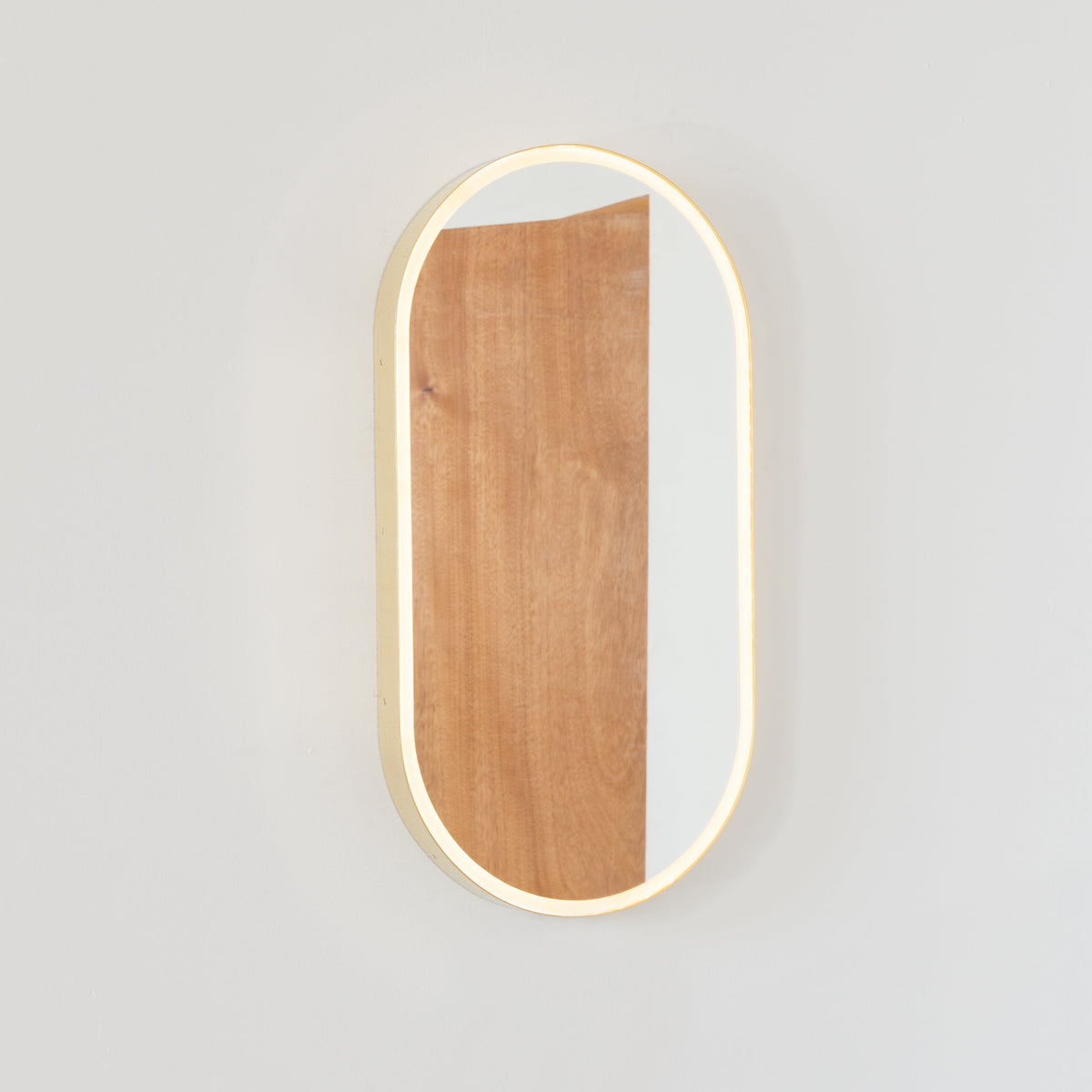 Capsula™ Front Illuminated Capsule shaped Mirror with Bronze Patina Brass Frame, Customisable