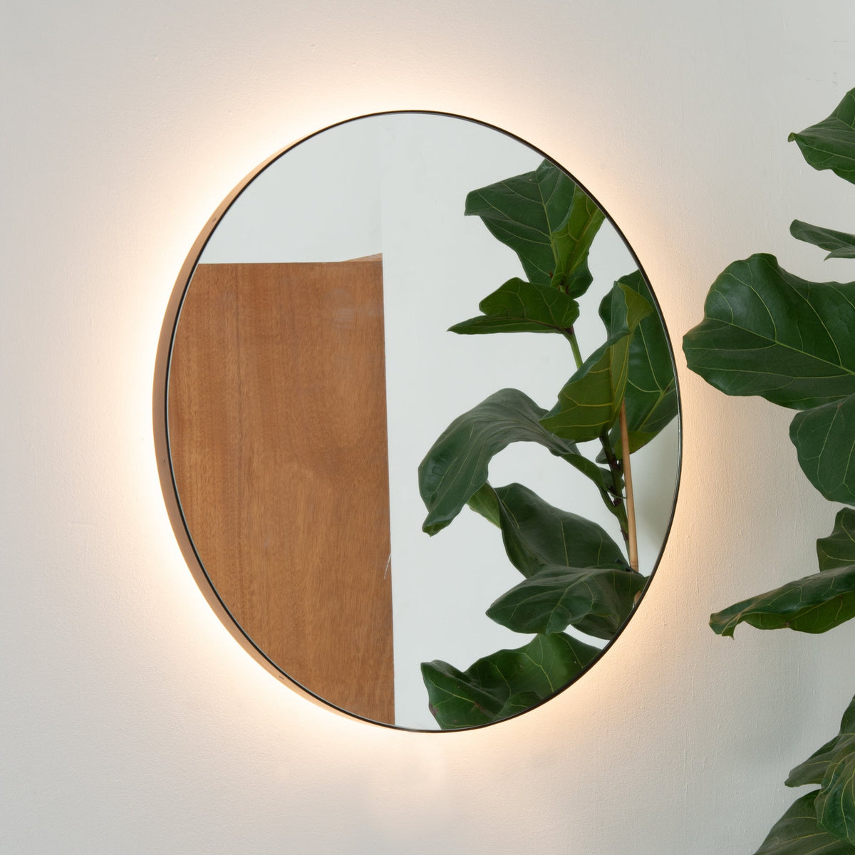 Orbis™ back Illuminated round mirror with an elegant bronze patina brass frame