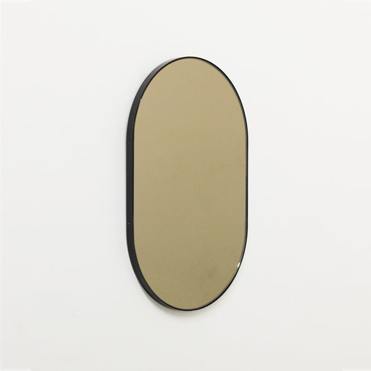 Capsule shaped Bronze Contemporary Mirror with a Black Frame