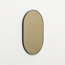 Capsule shaped Bronze Contemporary Mirror with a Black Frame