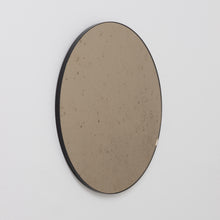 Orbis™ Antiqued Bronze Tinted Round Elegant Mirror with a Black Frame