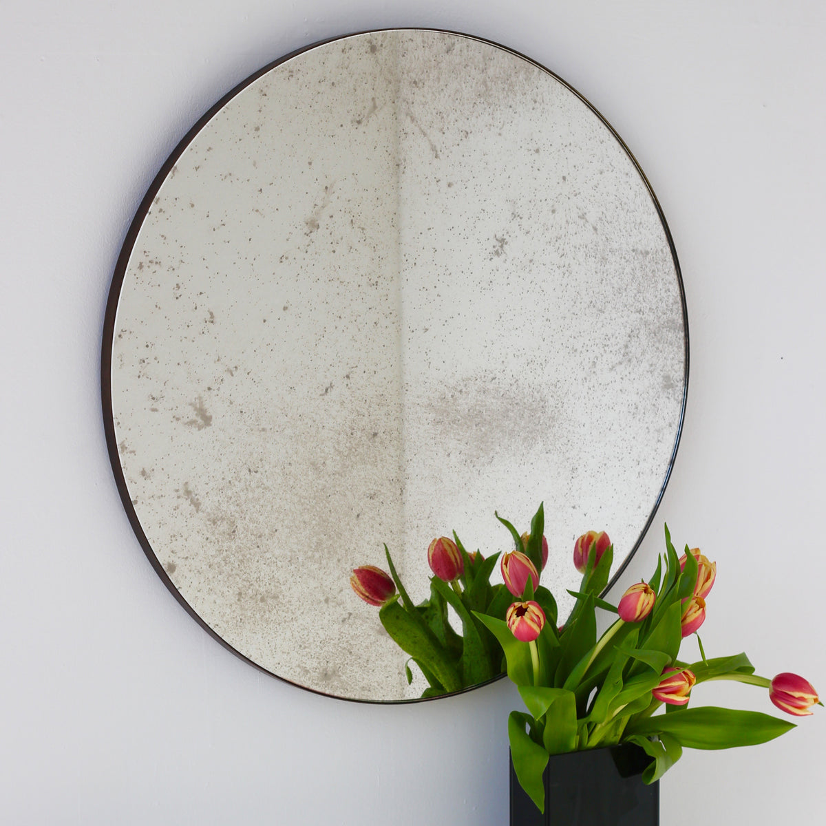 Orbis™ Antiqued Round Mirror with a Handcrafted Bronze Patina Frame